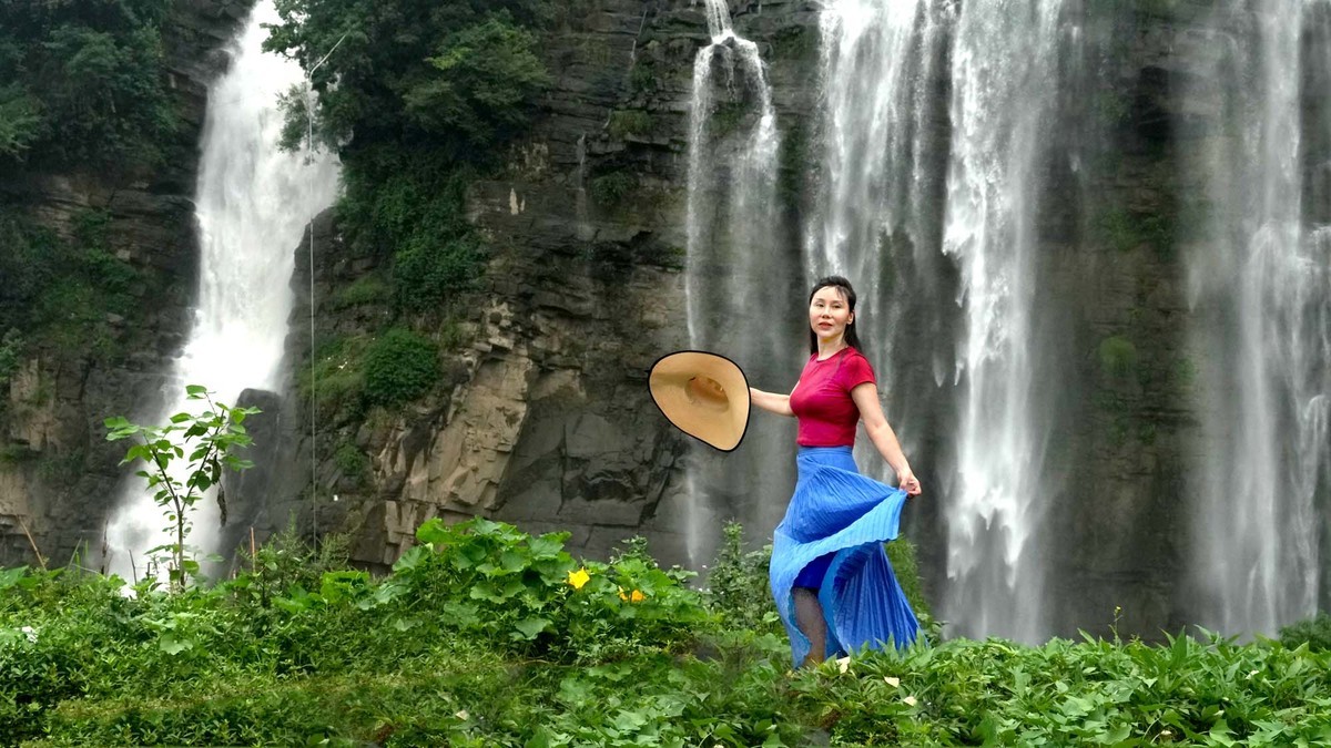 清凉瀑布下的红衣女子