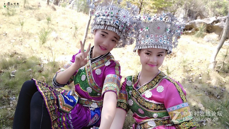 用手机拍穿苗族装的女孩